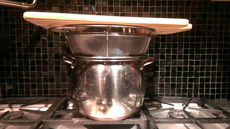 Steaming cutting board over pot